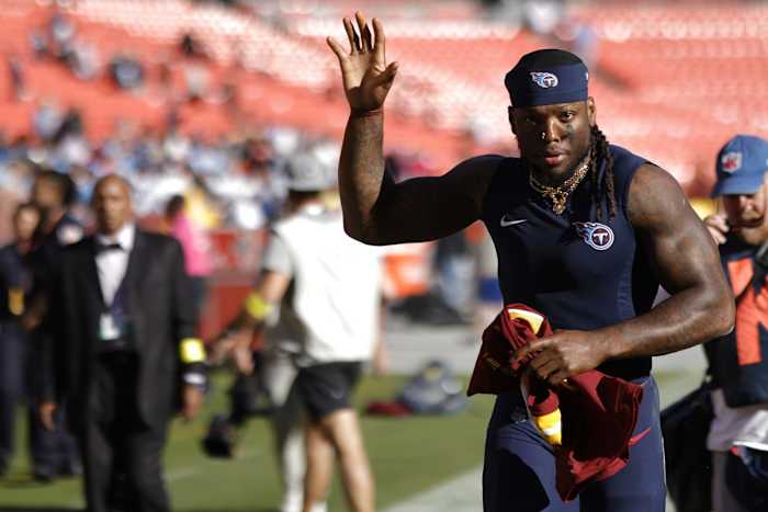 Tennessee Titans running back Derrick Henry waves to fans while leaving the field after the Titans' game against the Washington Commanders at FedExField.